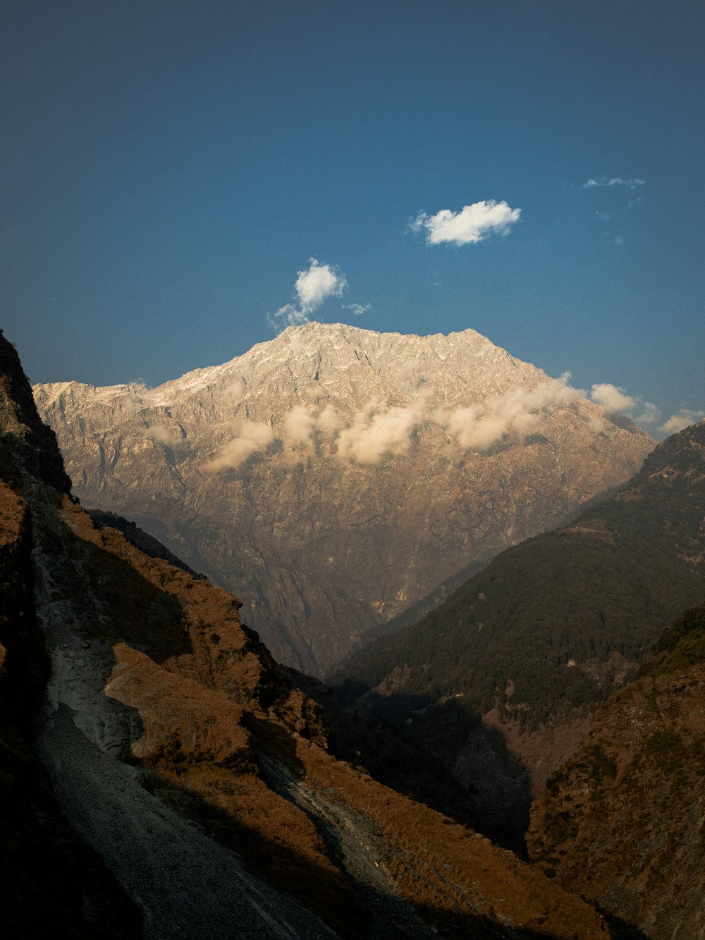 a view of a mountain range with clouds in the sky