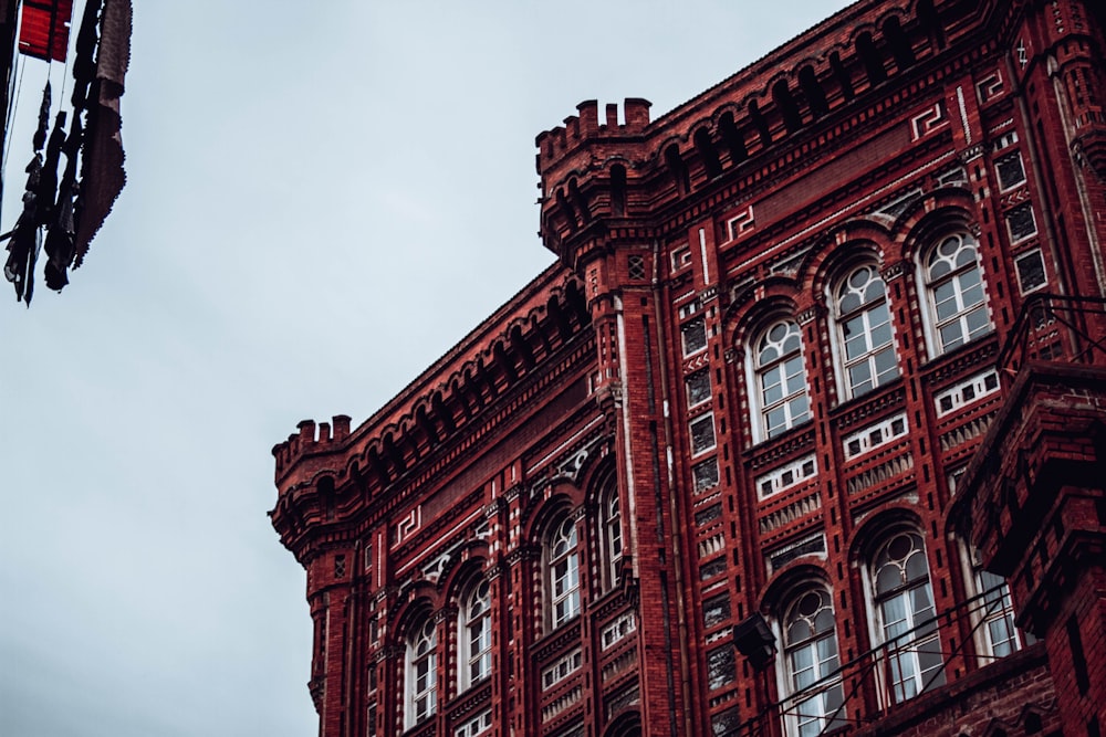 a tall red building with a clock on the side of it