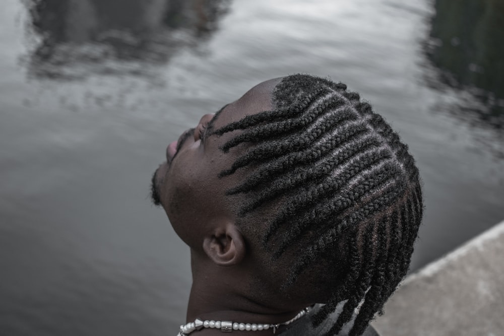 a woman with braids looking at the water