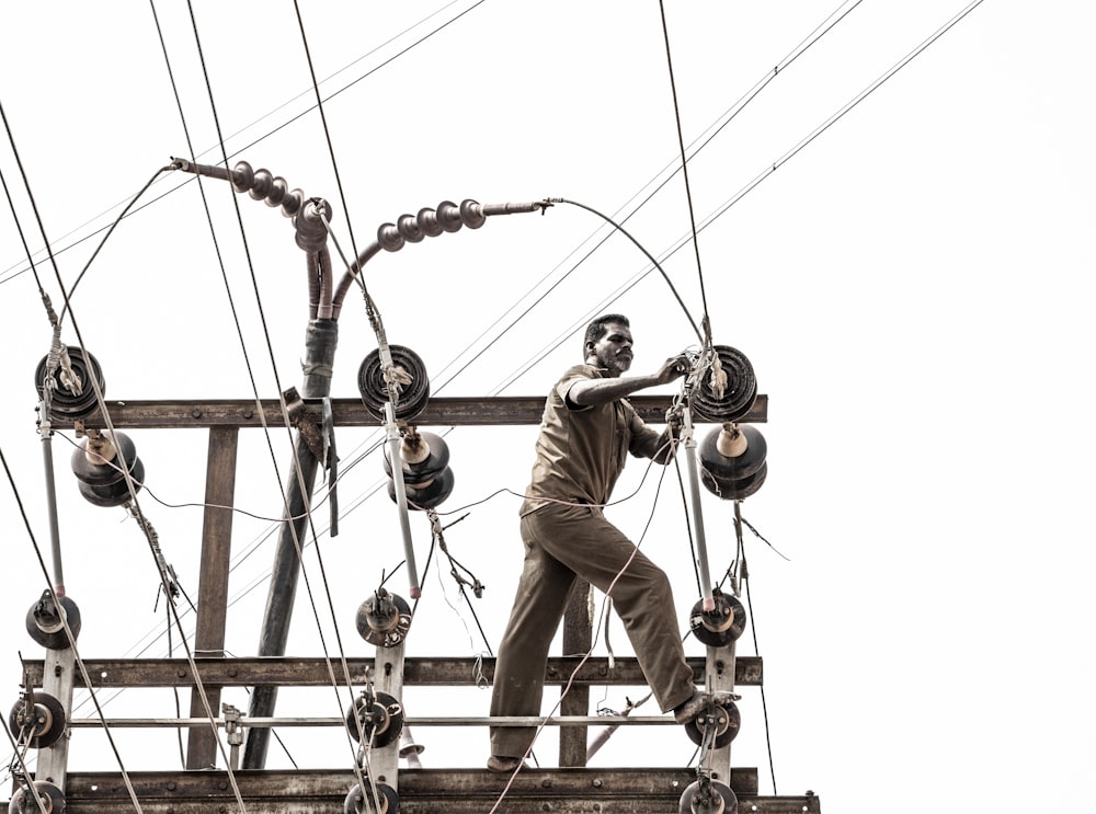 a man standing on top of a wooden structure