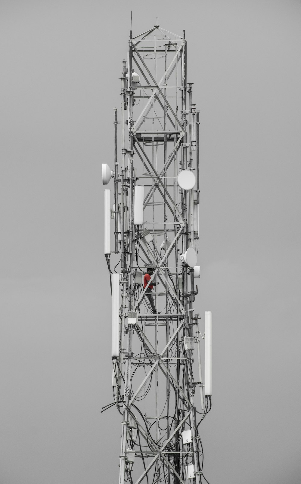 a tall tower with many antennas on top of it