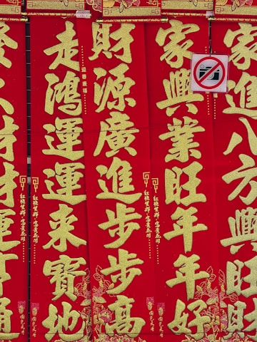 A vibrant banner showing Zambia's Victoria Falls blending into Beijing's Forbidden City under national flags.