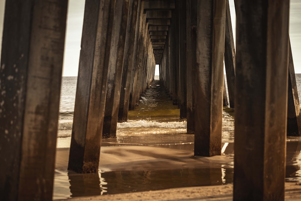 a view of the ocean from underneath a pier