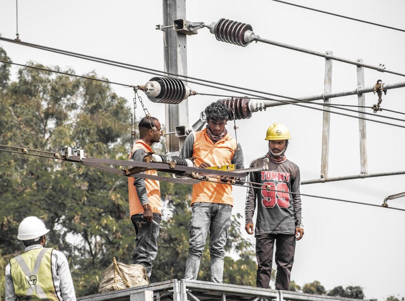 Electricians working on power lines in India