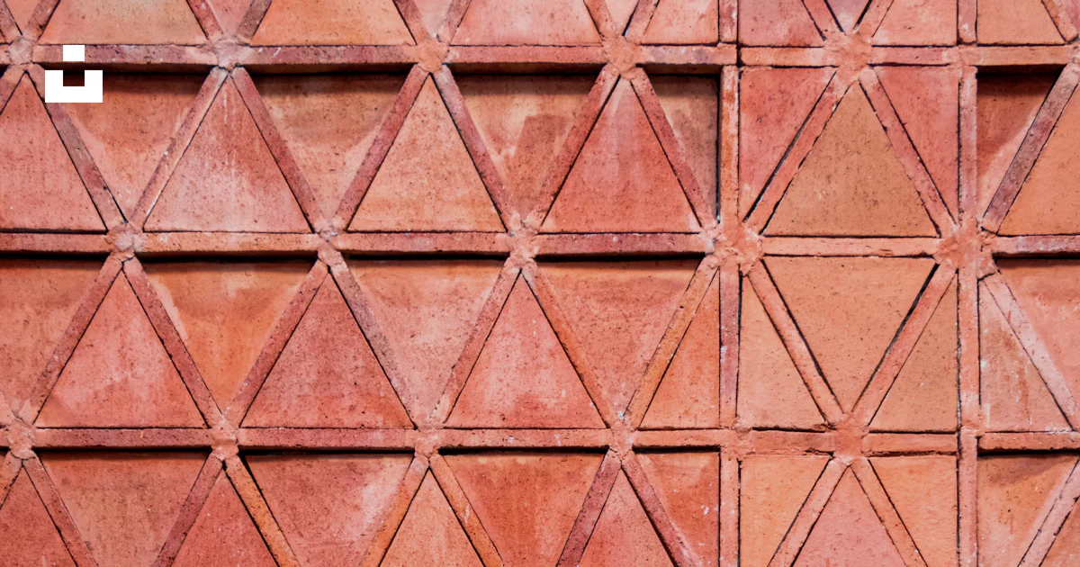Triangular Brick Patterns A close up of a wall made of red bricks photo – Free Triangle Image on ...