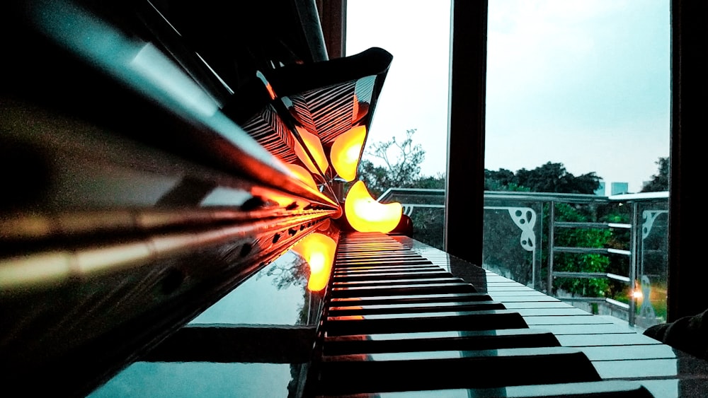 a piano sitting in front of a window