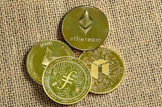 three gold coins with a bitcoin on top of them