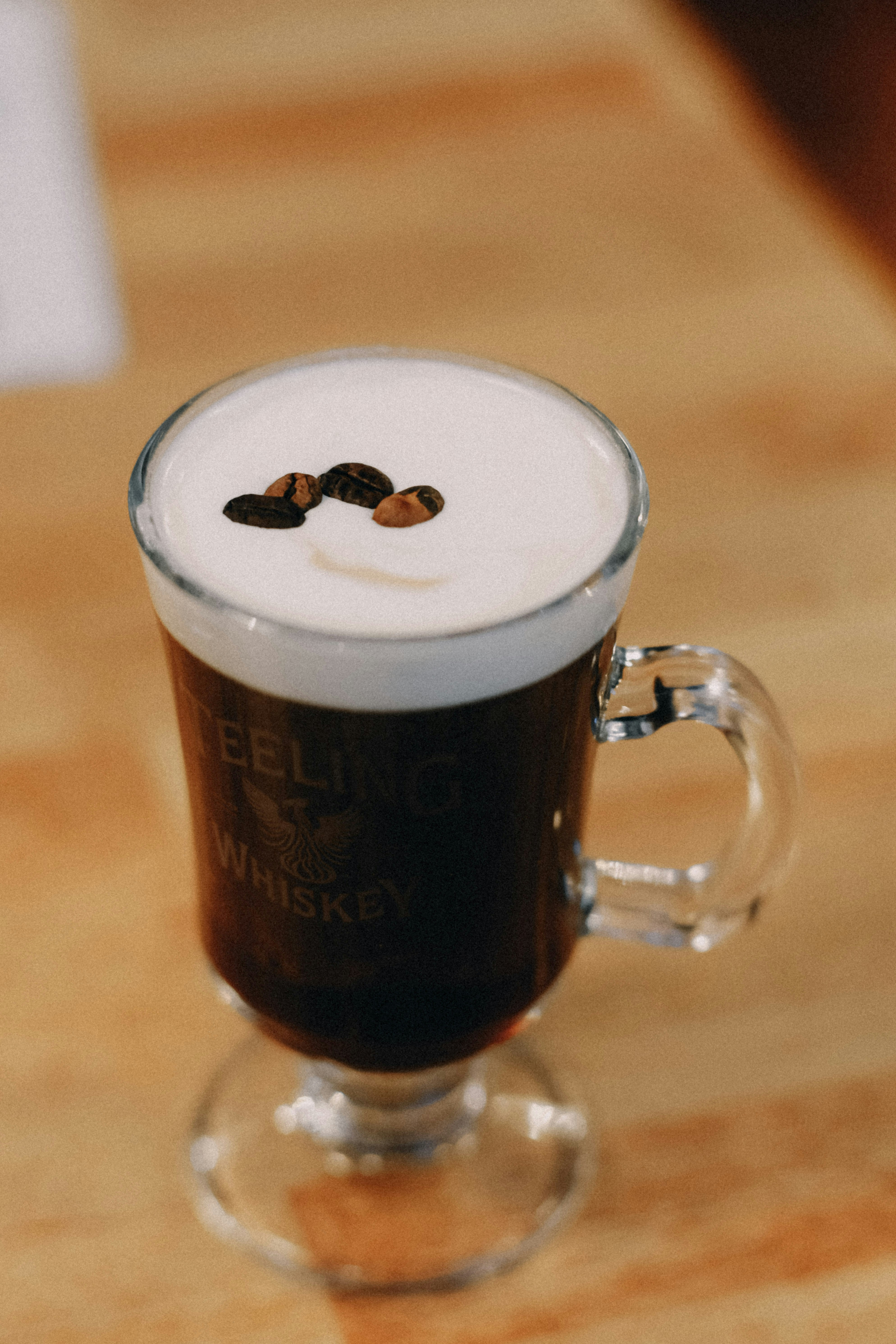a cappuccino is sitting on a wooden table