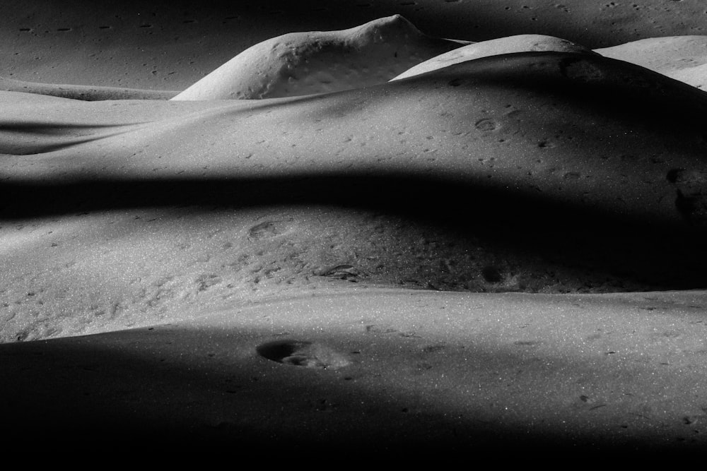 a black and white photo of sand and water