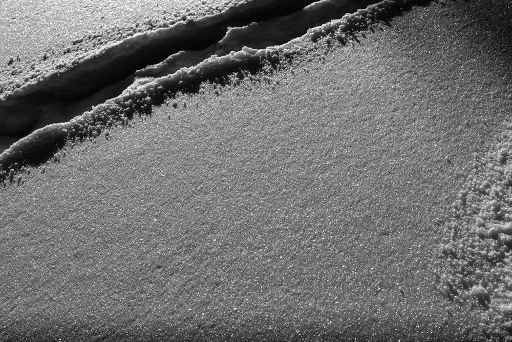 a black and white photo of snow on the ground