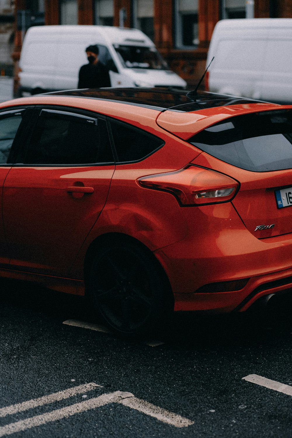 a red ford focus parked in a parking lot