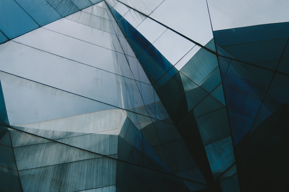 a close up of a glass building with a sky in the background