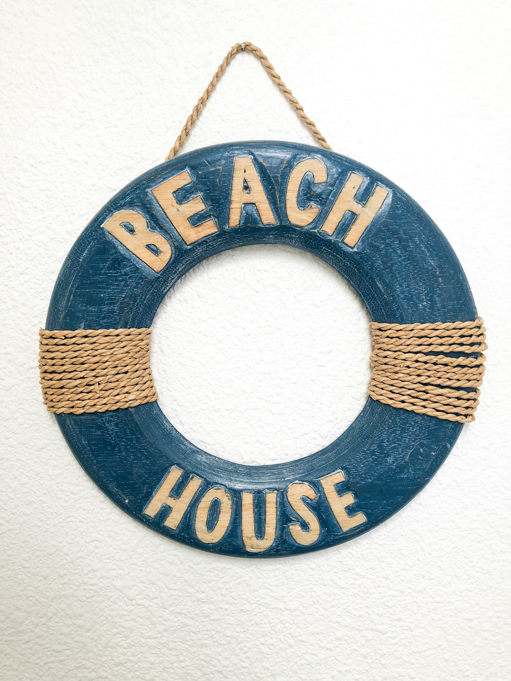 a blue life preserver hanging on a wall