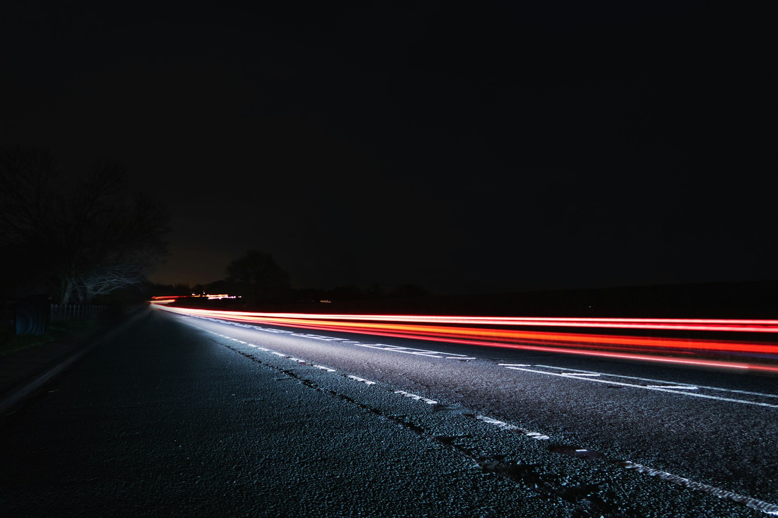 A long exposure photo of a highway at night