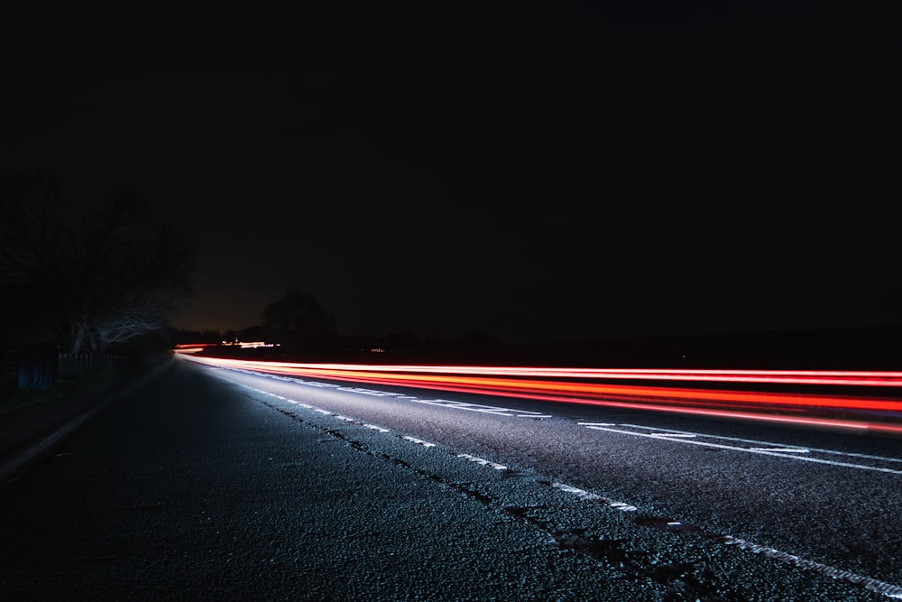 a long exposure photo of a highway at night