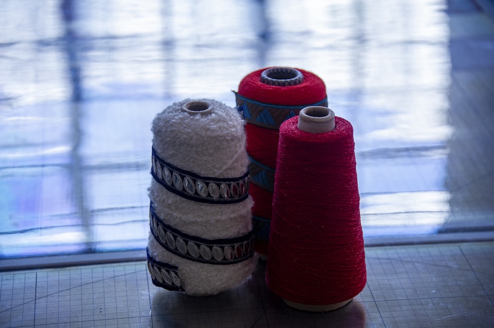 three spools of thread sitting next to each other