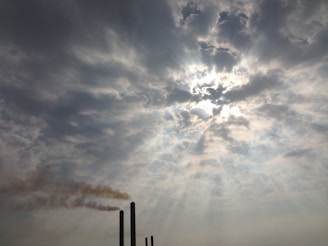 the sun is shining through the clouds in the sky