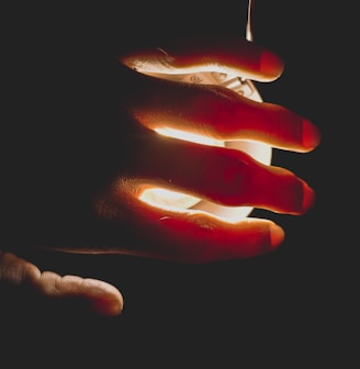 a person holding a lit object in their hand