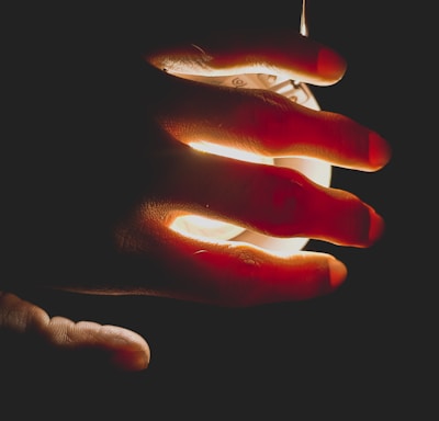 a person holding a lit object in their hand