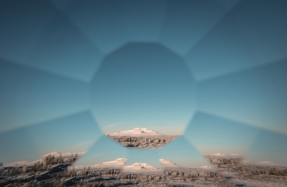 a view of a snowy mountain from a plane window