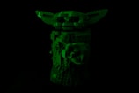 A dark image showcasing a Lego sculpture resembling a character with large ears and detailed features, primarily made from various-sized blocks.