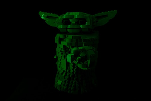 A dark image showcasing a Lego sculpture resembling a character with large ears and detailed features, primarily made from various-sized blocks.