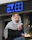 a woman sitting outside of a store holding a drink