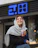 a woman sitting outside of a store holding a drink
