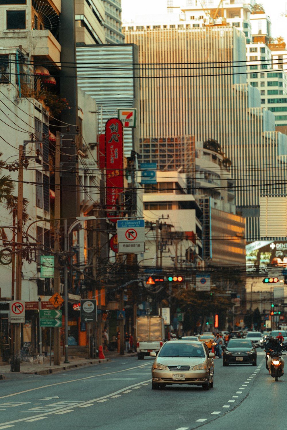 a city street filled with traffic next to tall buildings