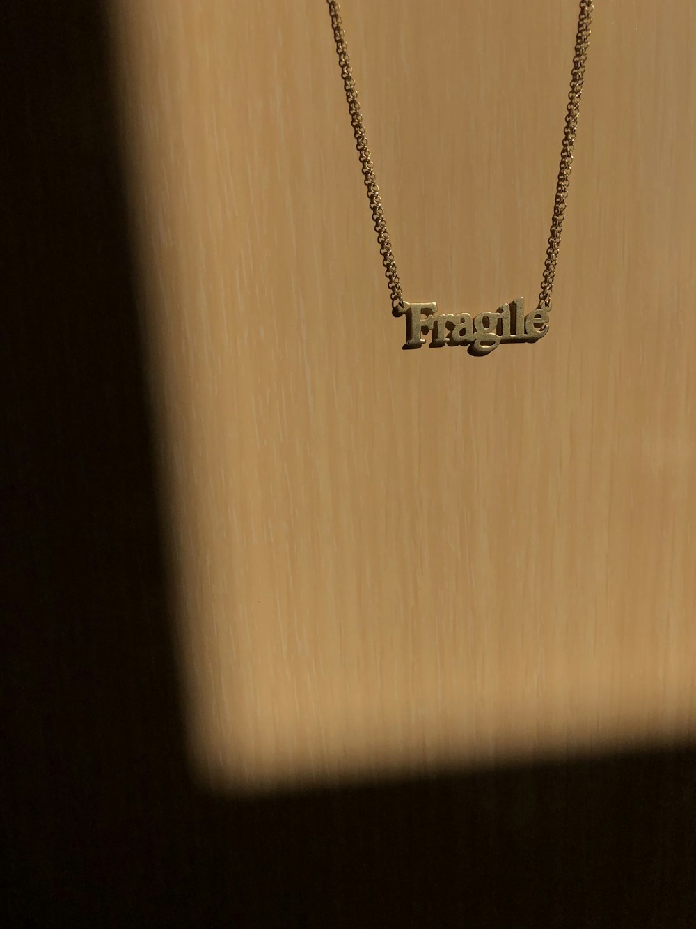 a necklace with the word angel on it
