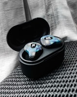 A colorful set of wireless earbuds in a compact charging case.