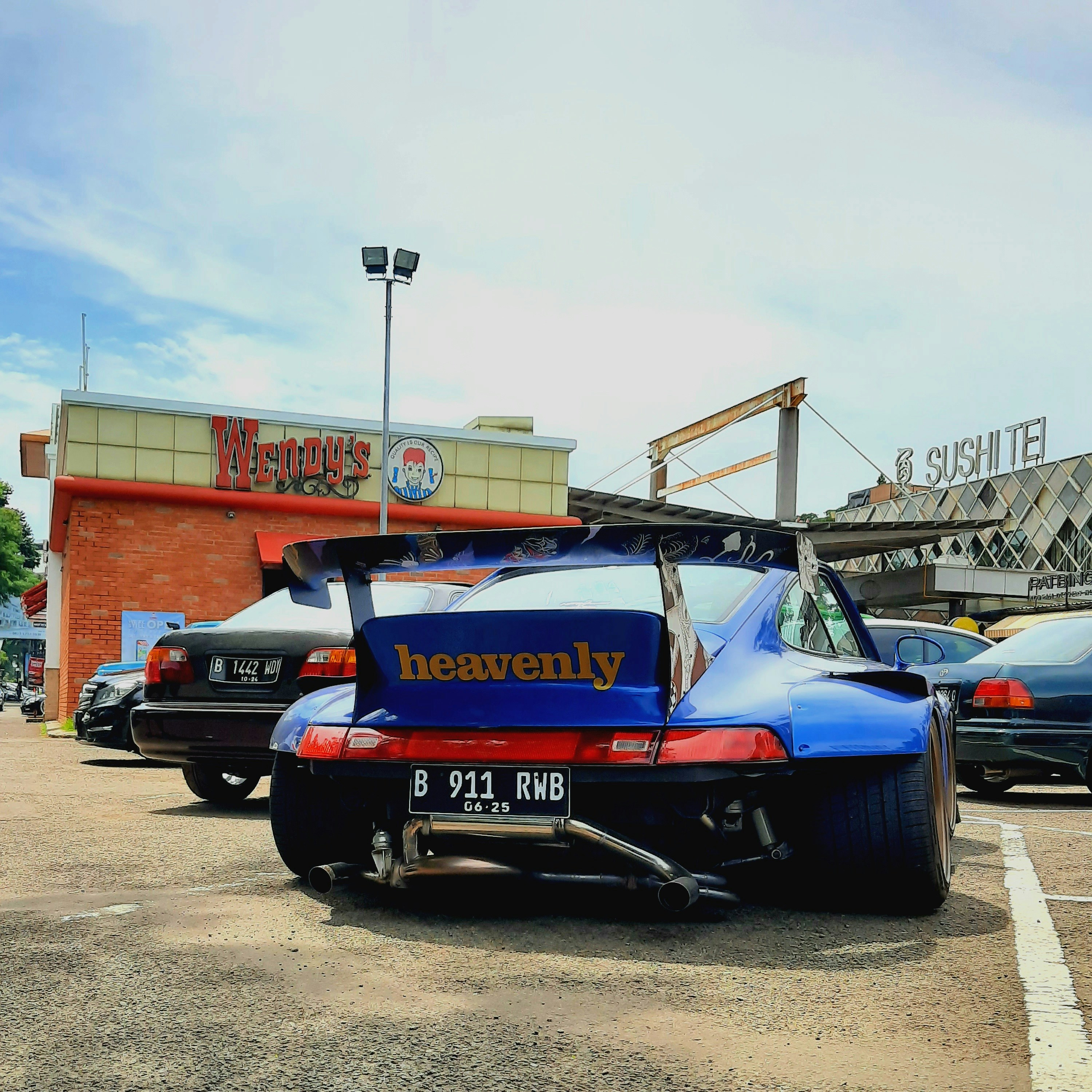 a blue sports car parked in a parking lot