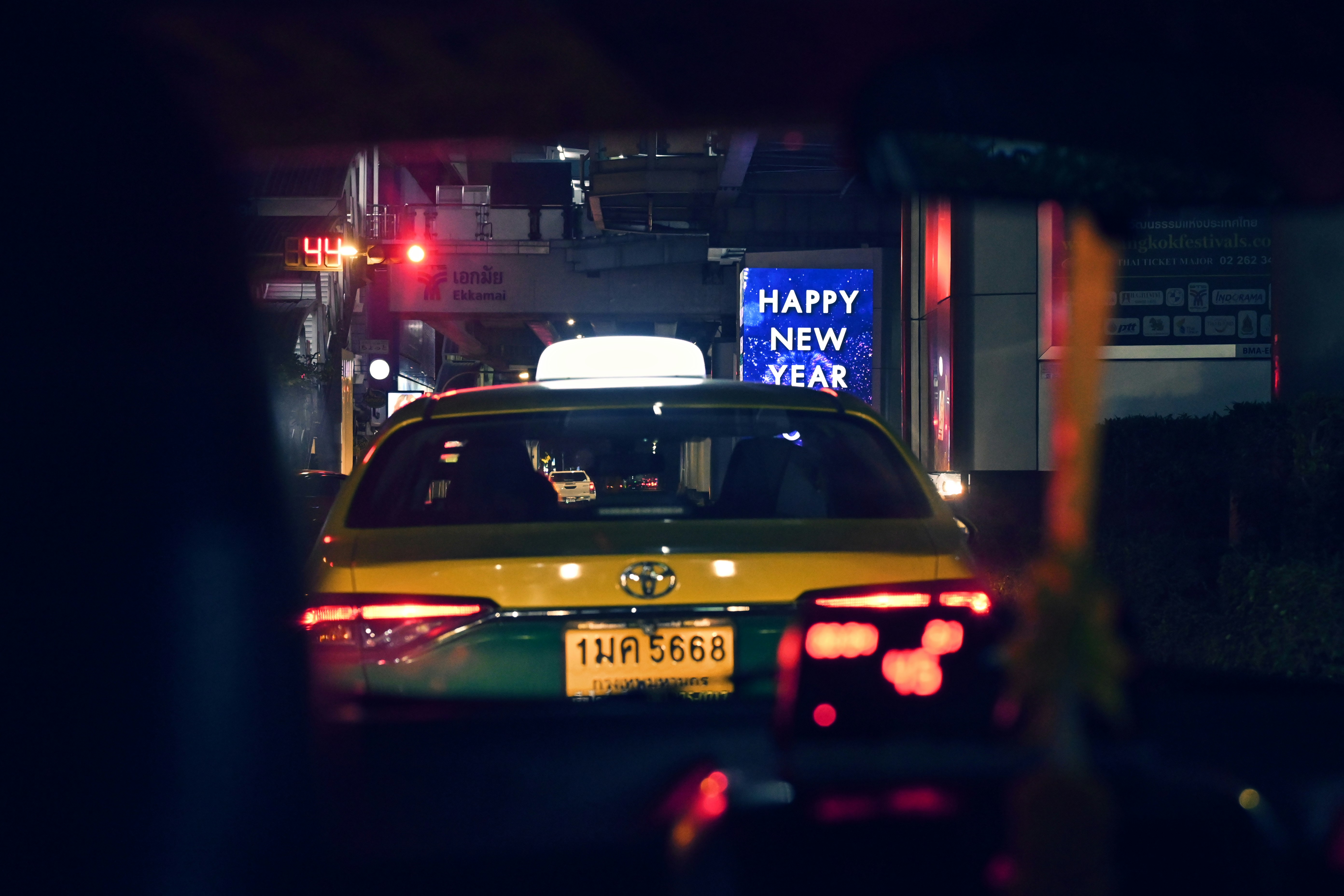 a taxi cab driving down a street at night
