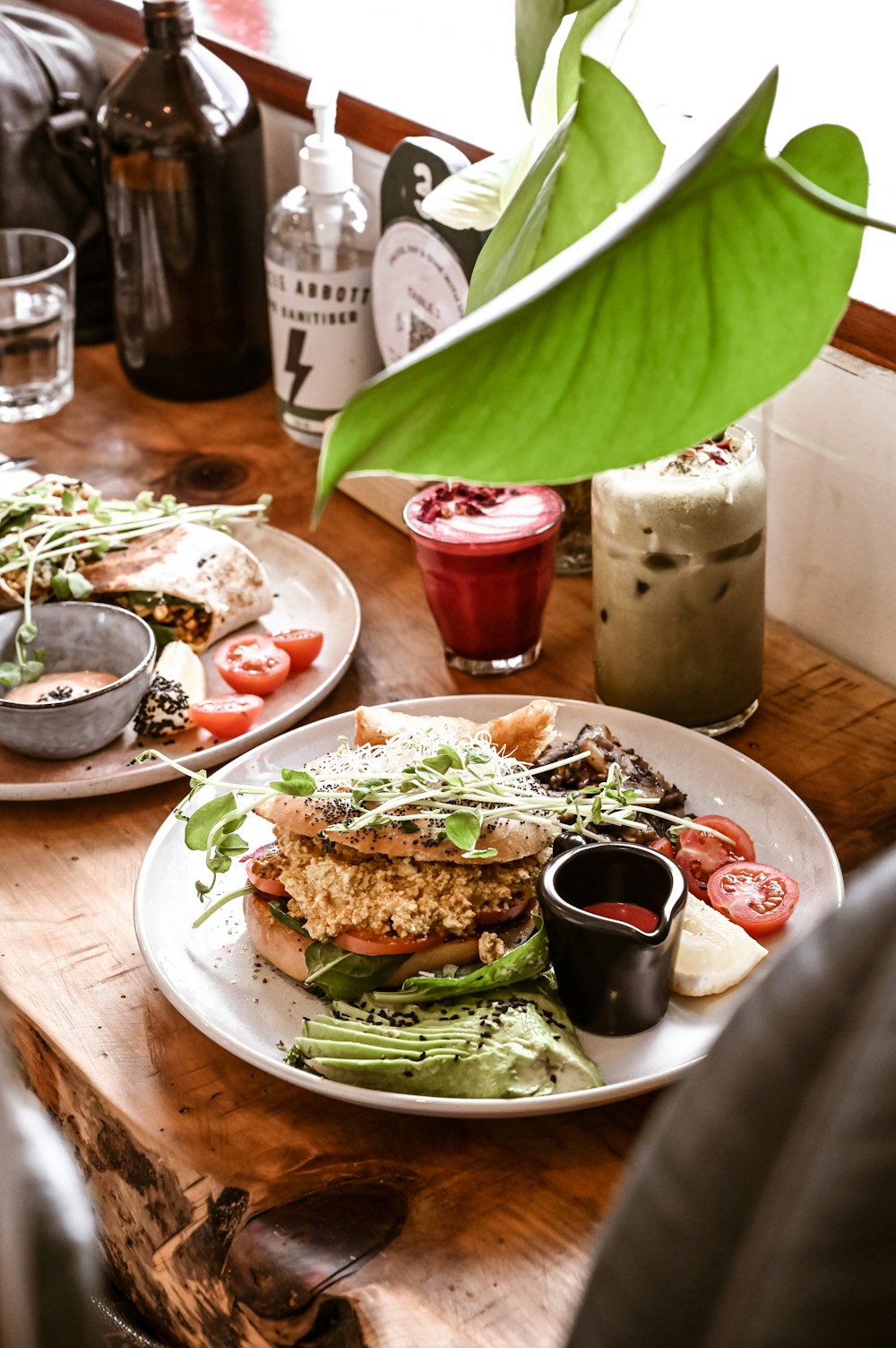 a wooden table topped with plates of food