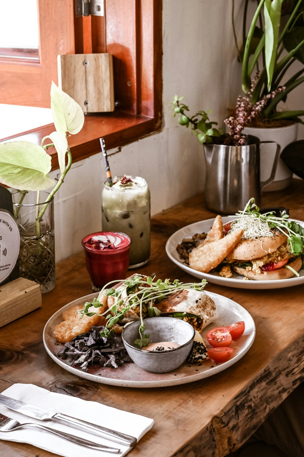 a wooden table topped with plates of food