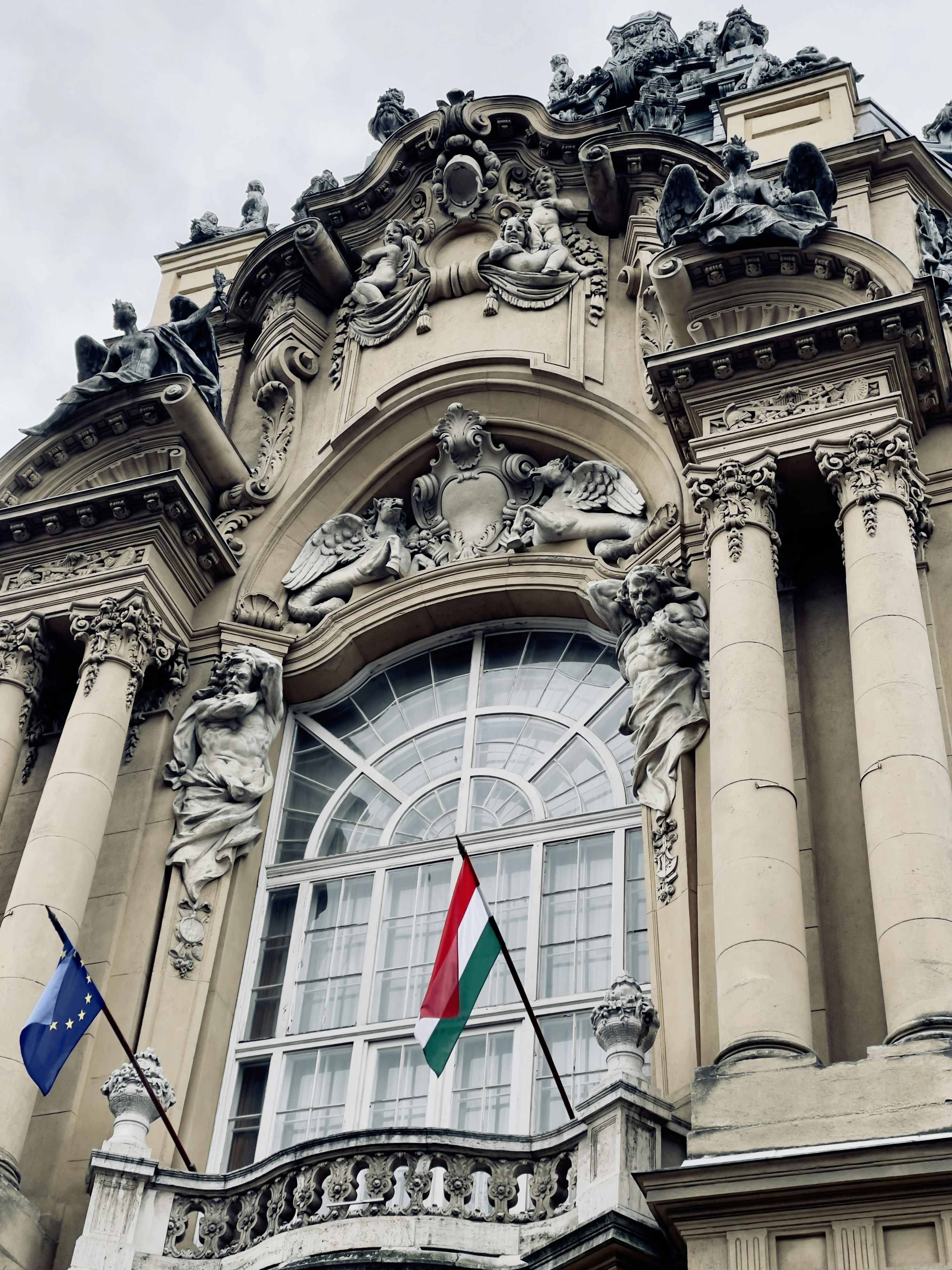 a large building with a flag flying in front of it