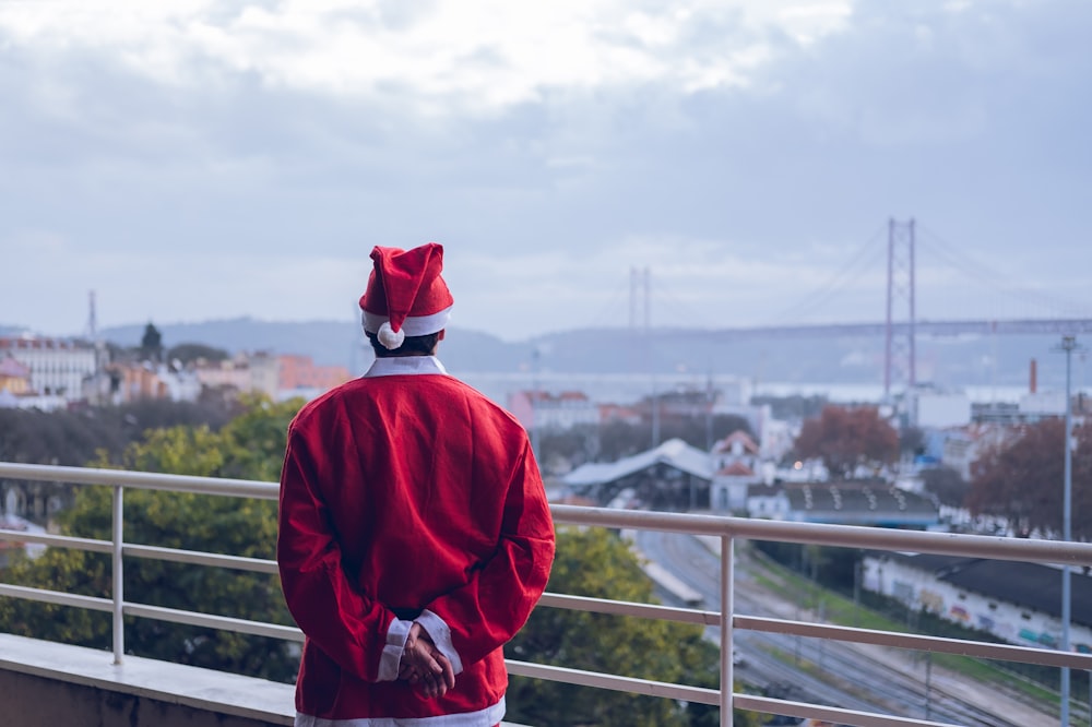 a man in a santa suit looking out over a city