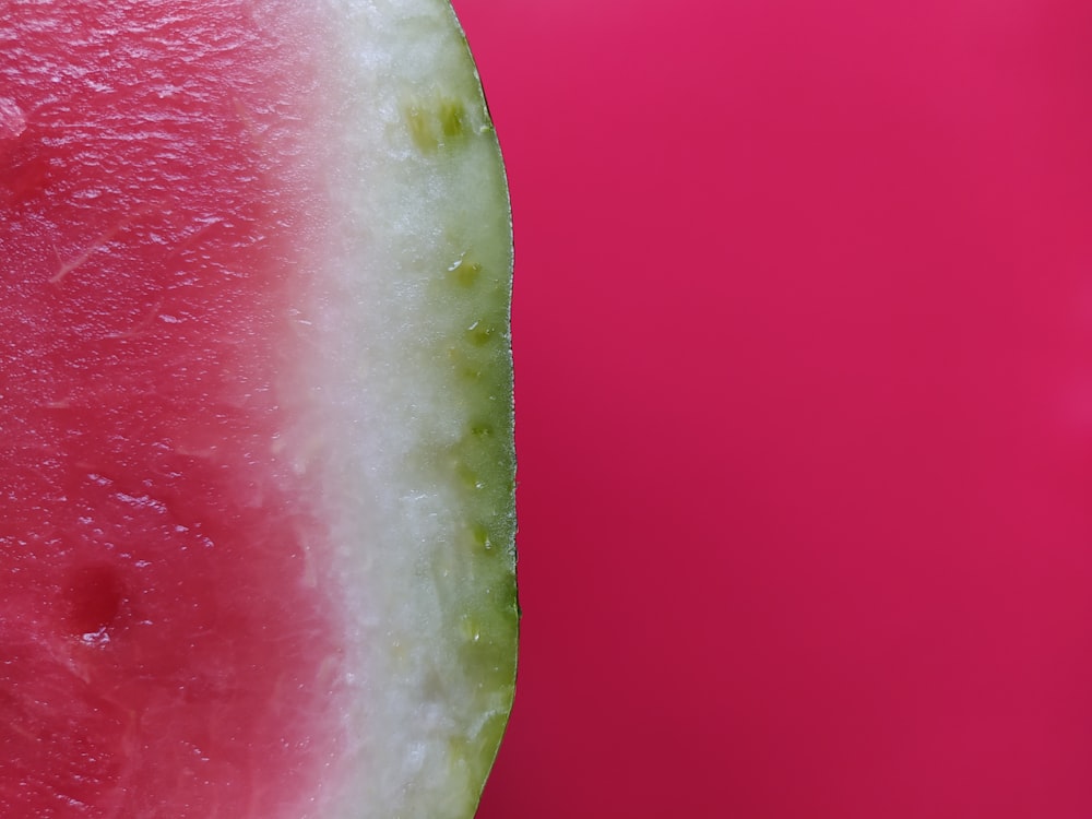 a slice of watermelon on a pink background