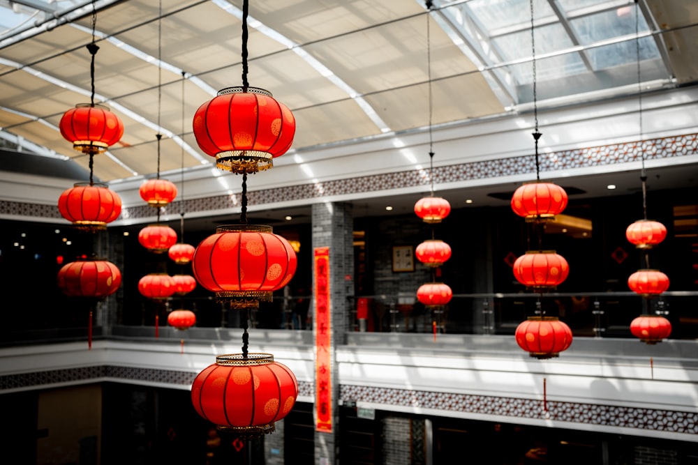 a group of red lanterns hanging from a ceiling