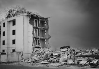 a black and white photo of a demolished building