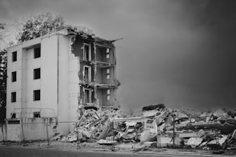 a black and white photo of a demolished building