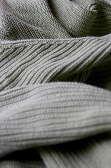 Close-up of Sekille's breathable sportswear fabric with intricate stitching details in a natural outdoor setting.
