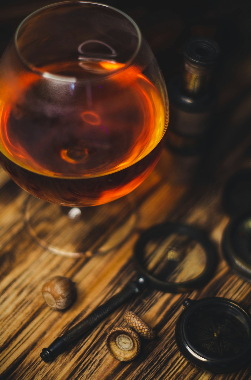 a glass of wine sitting on top of a wooden table