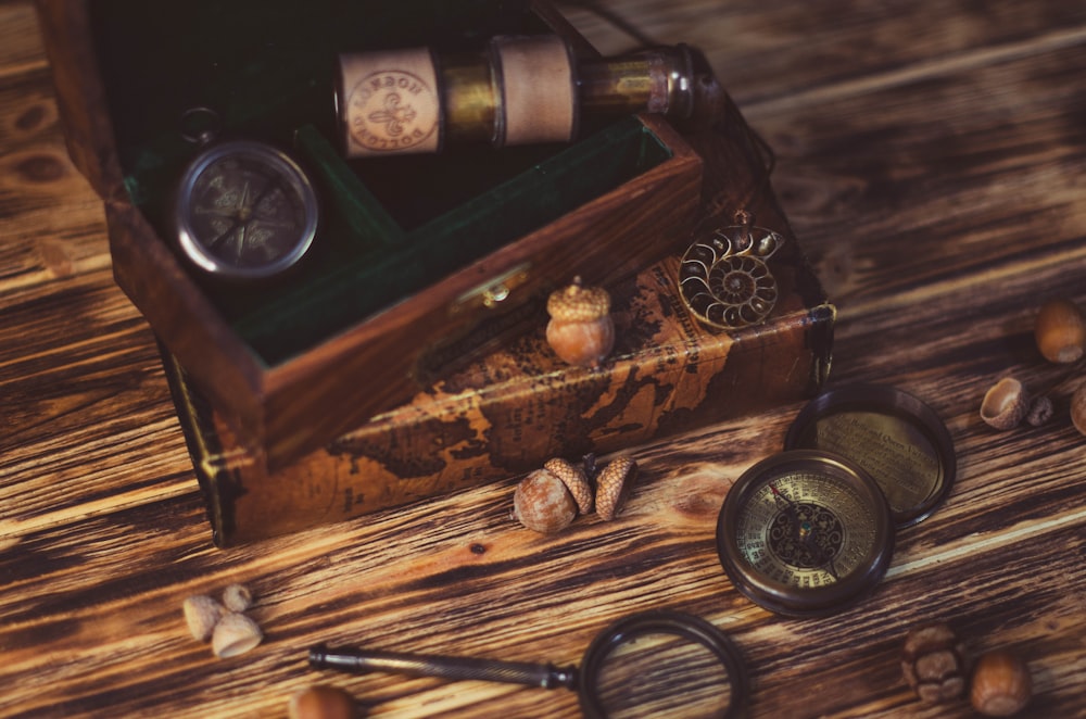 a wooden box filled with different items on top of a wooden table