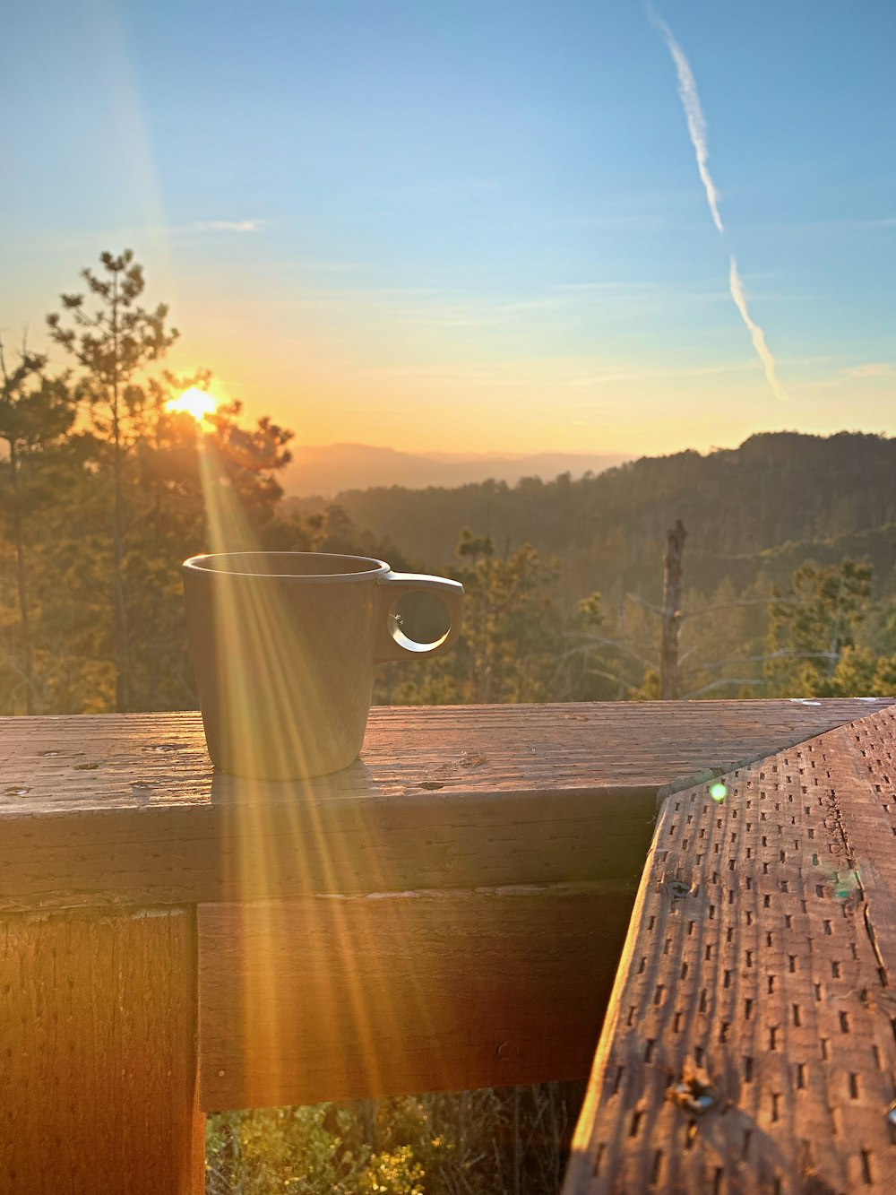 a cup of coffee sitting on top of a wooden table