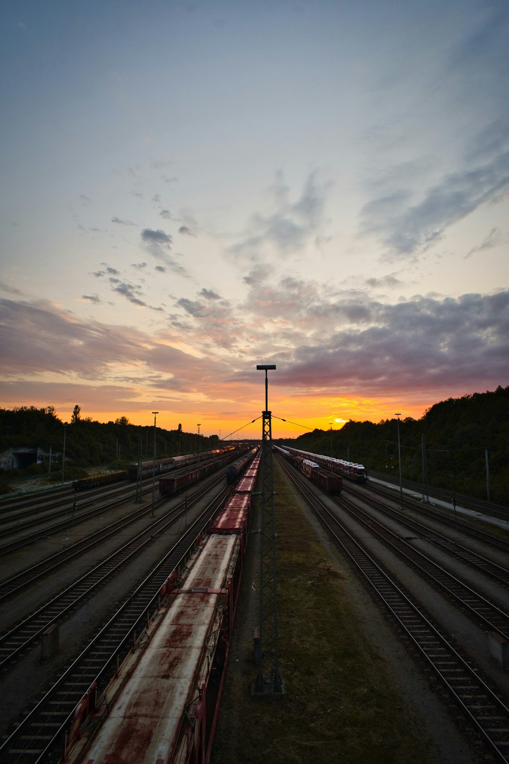 a train track with a sunset in the background