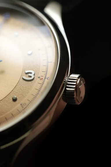 a close up of a watch on a black surface