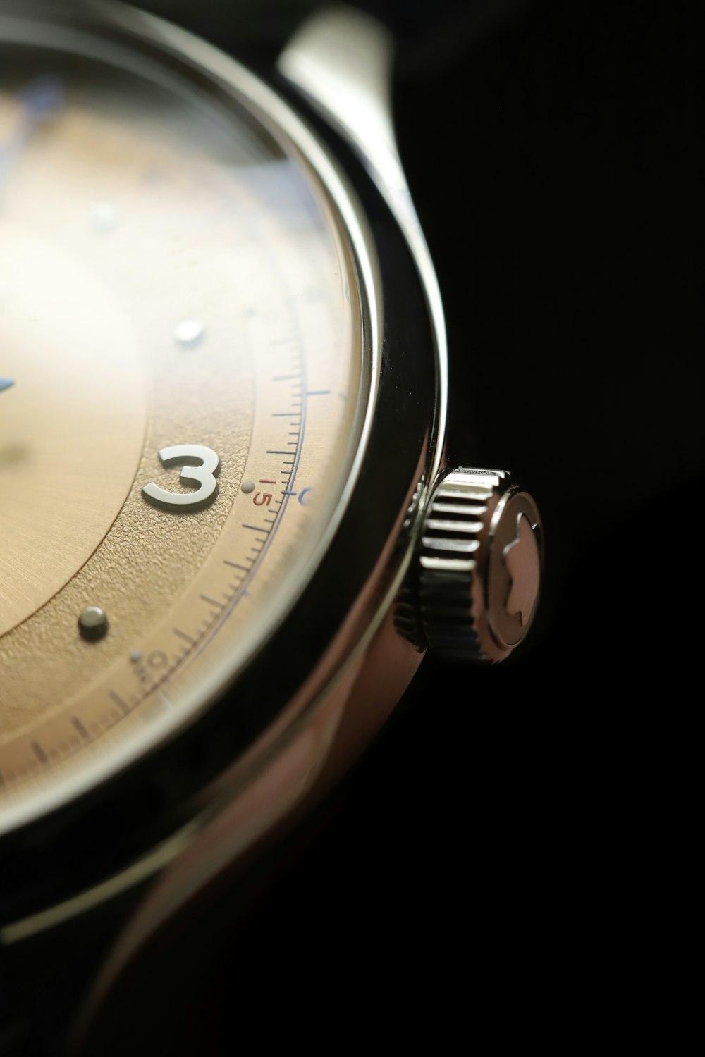 a close up of a watch on a black surface