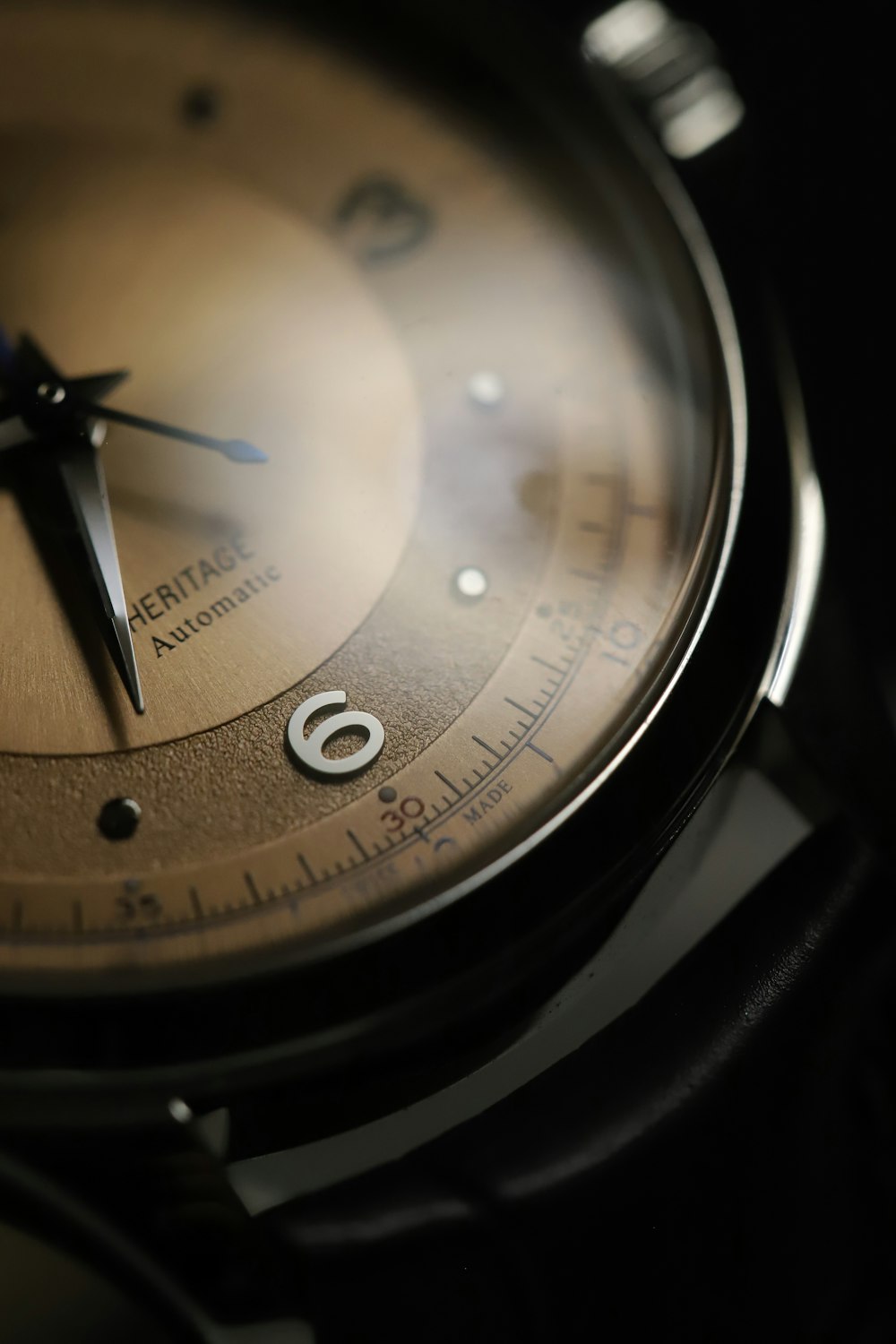 a close up of a watch on a black surface