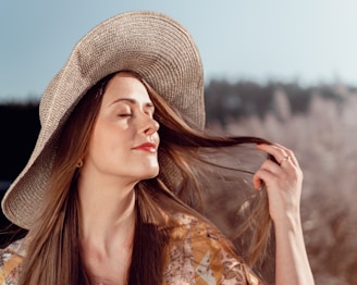 a woman with long hair wearing a hat